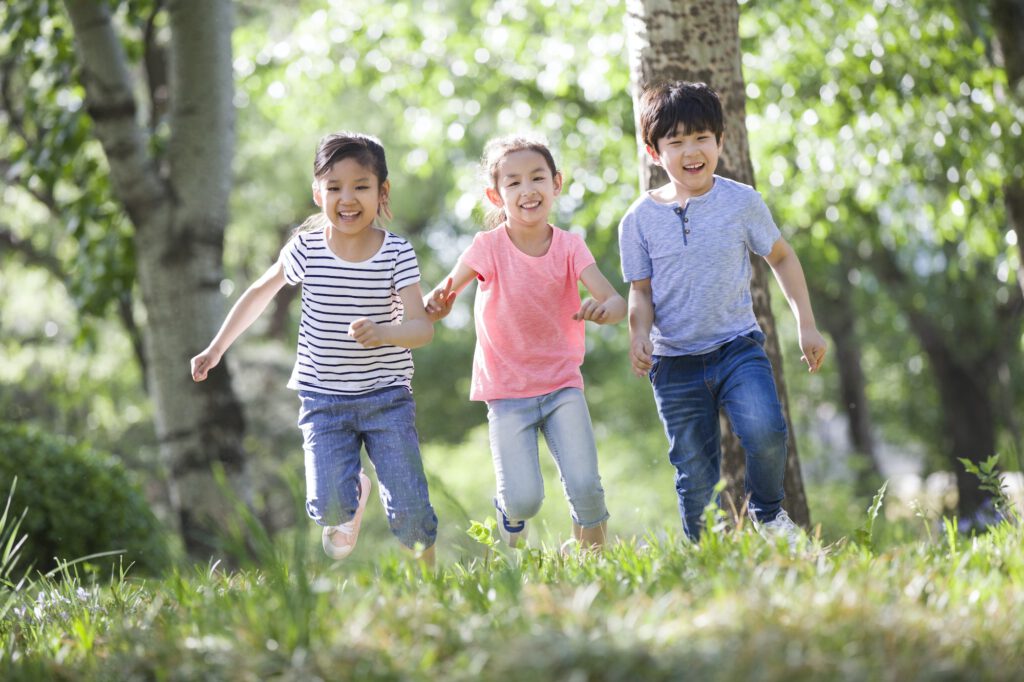 Happy children racing in woods